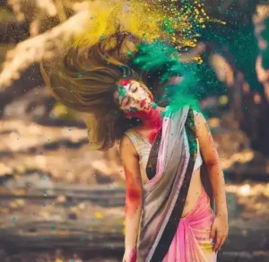 girl whipping hair with muti colored powder